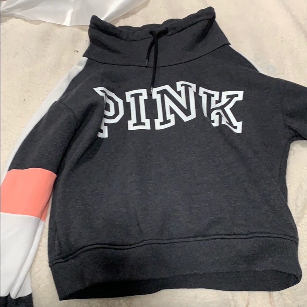 Pink sweaters with tie that has a semi hood